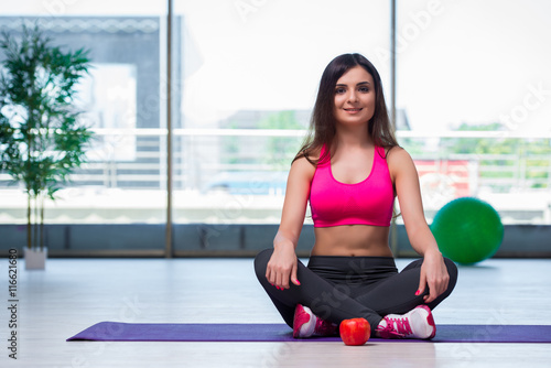 Young woman meditating in gym health concept
