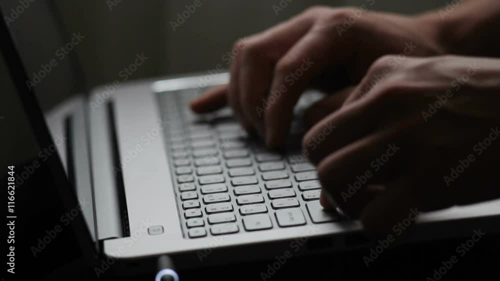 man typing on a laptop keyboard close up man typing on a laptop keyboard close up
