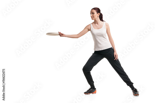 young happy woman playing with flying disc