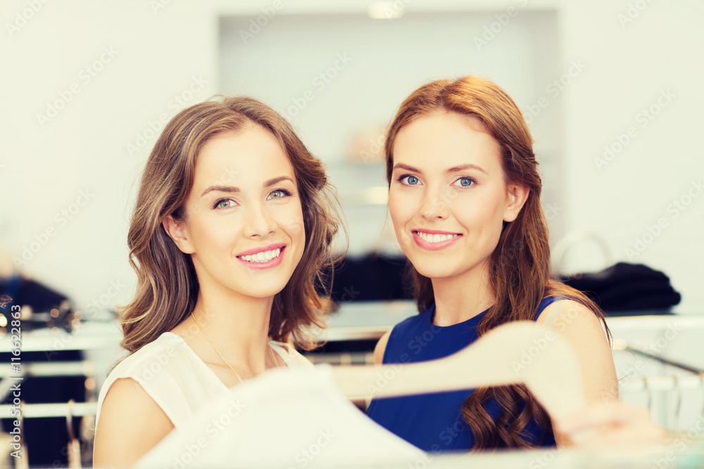 happy women with shopping bags at clothing shop happy women with shopping bags at clothing shop