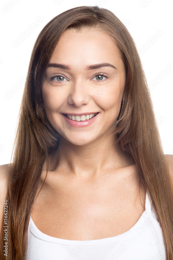 Portrait of happy beautiful attractive Caucasian young woman with long hair posing against white background. Front view of smiling cheerful girl wearing casual closing. Studio vertical image. Close-up Portrait of happy beautiful attractive Caucasian young woman with long hair posing against white background. Front view of smiling cheerful girl wearing casual closing. Studio vertical image. Close-up