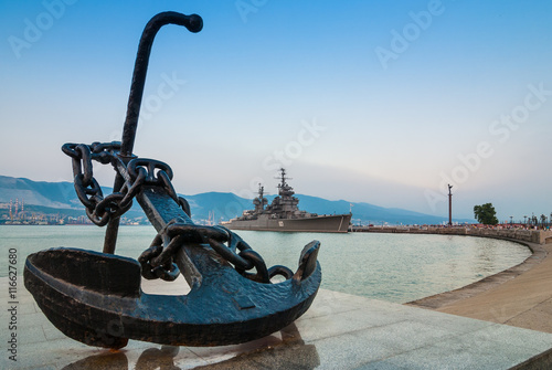 NOVOROSSIYSK, RUSSIA - JULY 7, 2010: Anchor on the embankment and the cruiser 