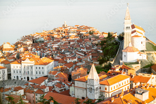 Aerial city scape view on Piran town with church tower and Adriatic sea on the background in Slovenia
