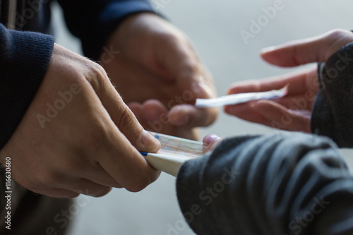 close up of addict buying dose from drug dealer