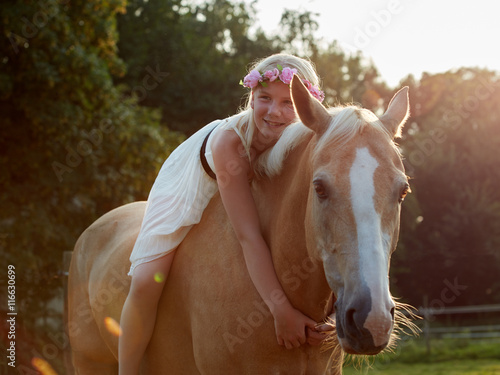 Girl hugs her horse