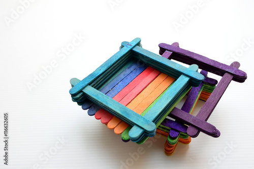 Colorful popsicle sticks over white background