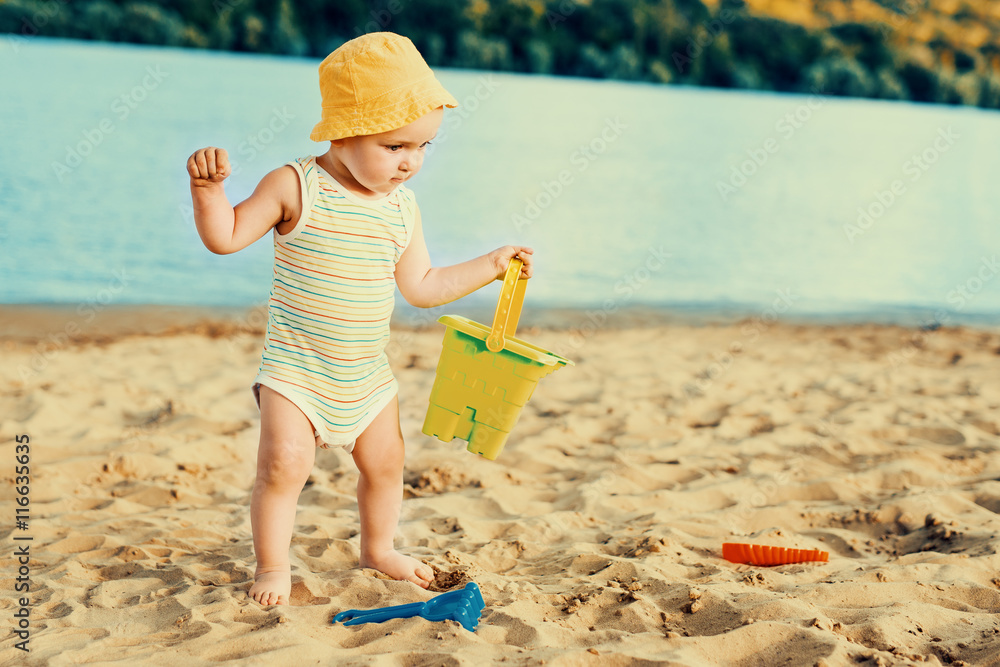 Baby boy playing with beach toys Baby boy playing with beach toys