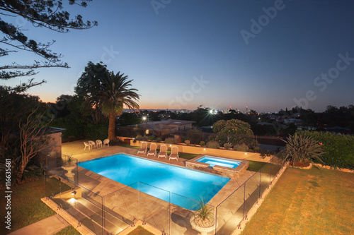 Luxury swimming pool area at night view from the above © JRstock