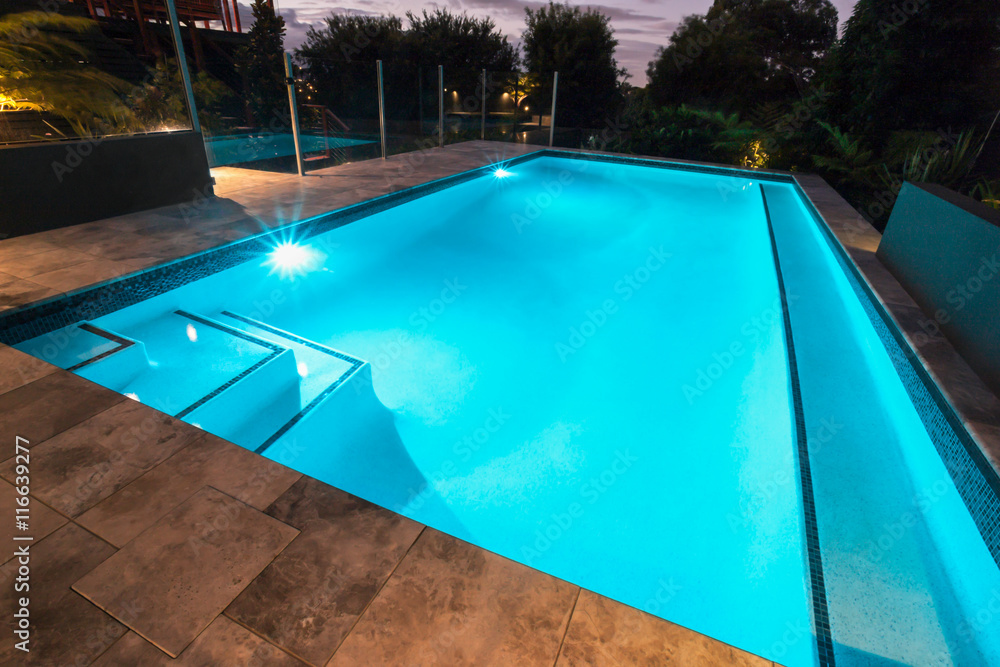 Blue water swimming pool with flashing lights with floor tiles