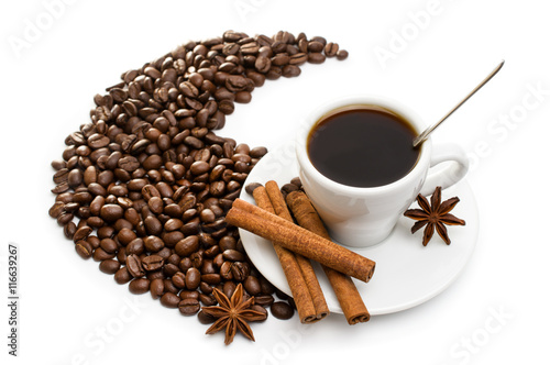 cup of coffee with cinnamon sticks, anise and chocolate