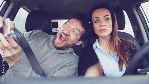 Couple driving car taking selfie almost getting into accident
