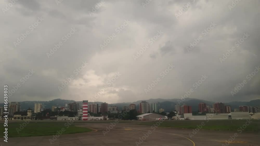 Guatemala City, Guatemala - June, 2016 - Tracking shot of the landing strip at La Aurora International Airport. Guatemala City, Guatemala - June, 2016 - Tracking shot of the landing strip at La Aurora International Airport.