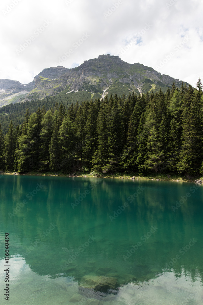 Reflections of the mountains in Obernberger See Tyrol Austria