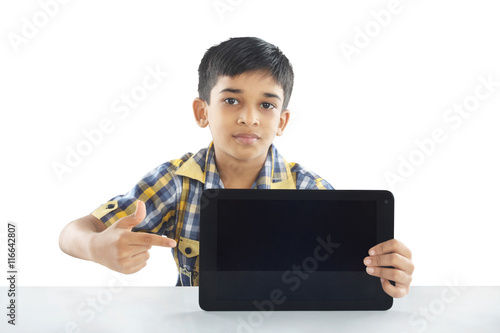 Indian boy holding tablet © V.R.Murralinath