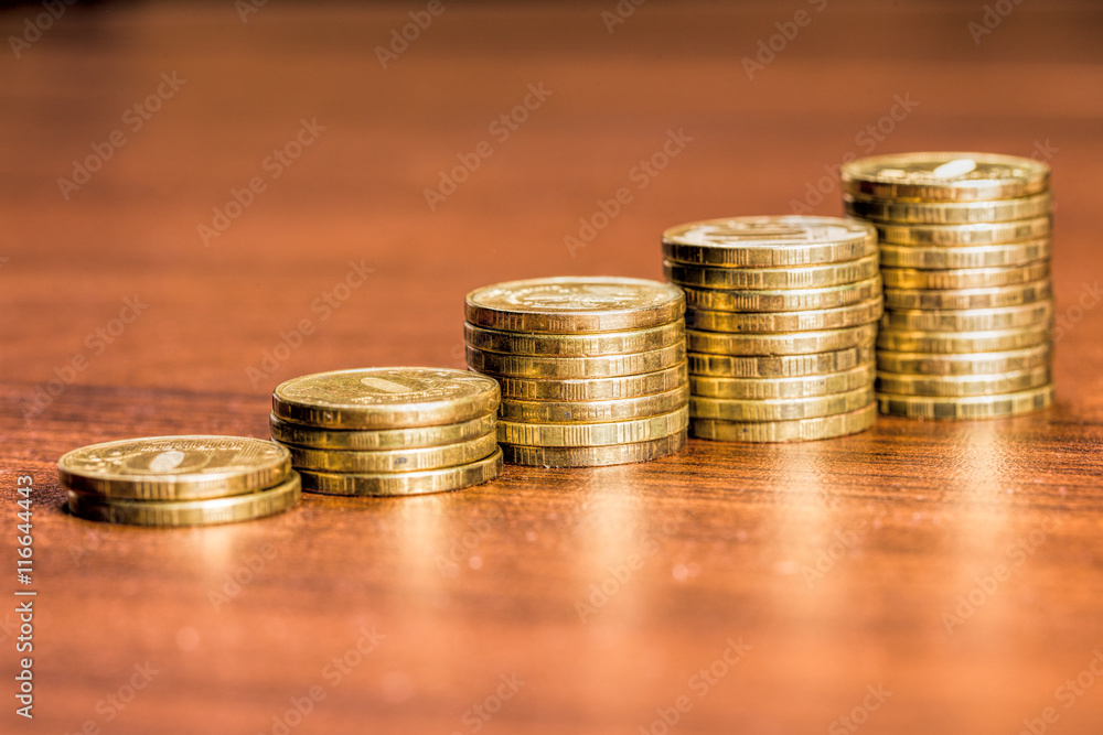 Stacks of gold coins of various heights Stacks of gold coins of various heights