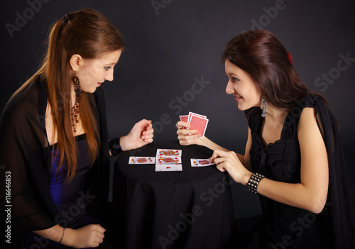 Canvas Print Two girls friends engaged in fortune-telling cards