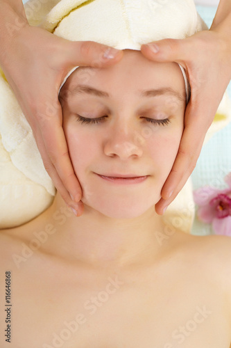 Man's hands do woman's face massage