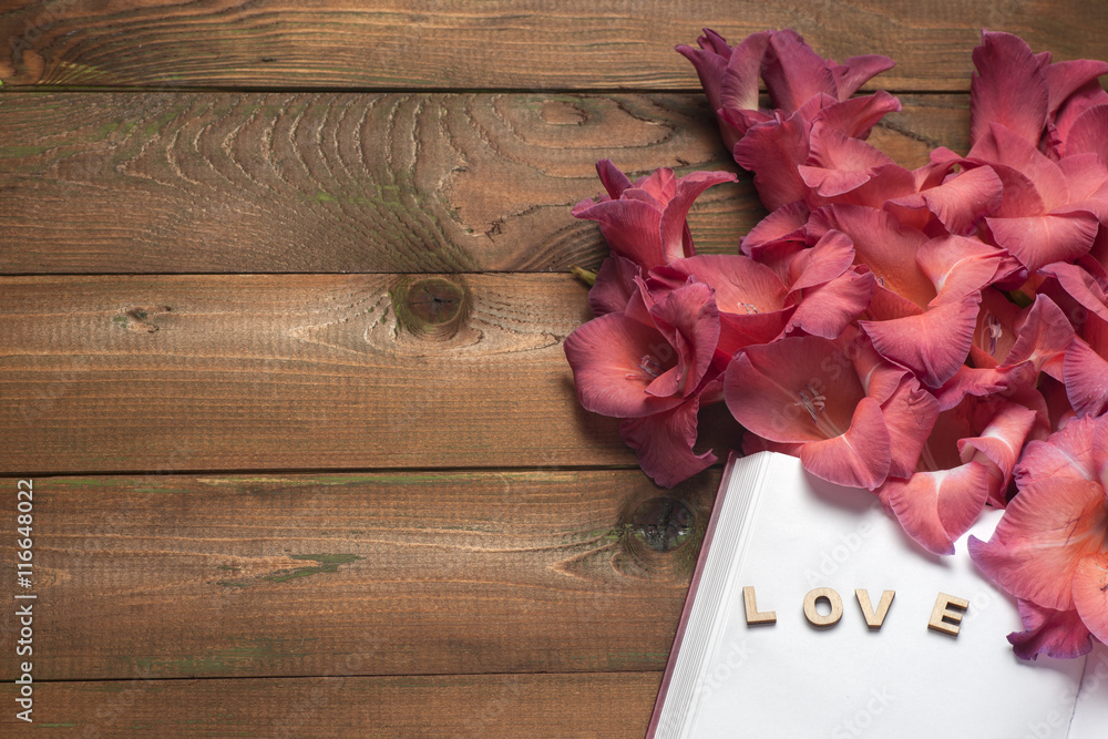 The word love a lot of hearts on a background of book on a wooden table. Back to school copy space. Education background. The word love a lot of hearts on a background of book on a wooden table. Back to school copy space. Education background.