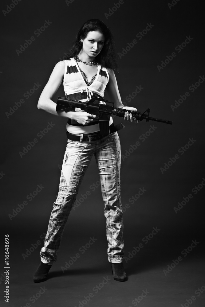Girl holding a rifle - monochrome picture Girl holding a rifle - monochrome picture
