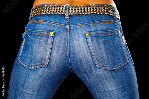 Fototapeta Naklejka Na Ścianę i Meble -  Female ass dressed in jeans on black