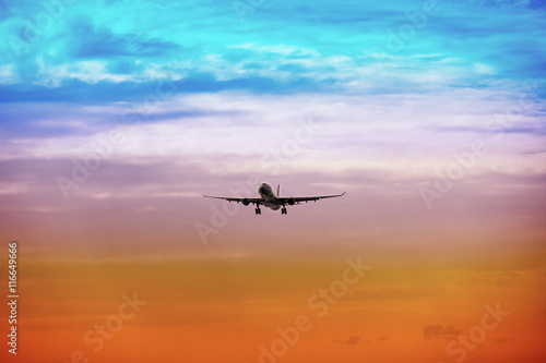 Passenger plane takes off at sunset © pzAxe