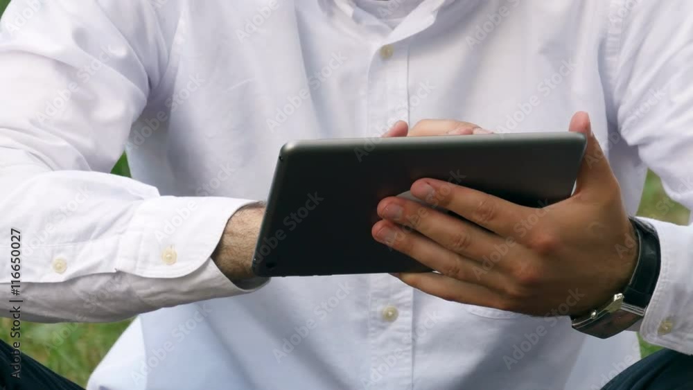 Businessman man hand using tablet device outdoor Businessman man hand using tablet device outdoor