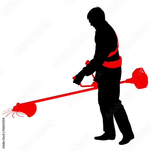 Silhouette worker of a garden cuts off  grass. 
