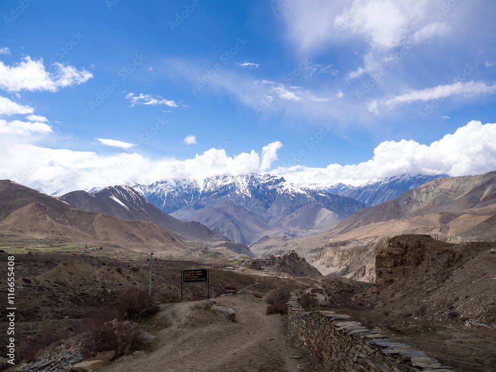 View of the snow mountain and Nepalese village on the way between Muktinath and Jharkot, Annapurna Conservation Area, Nepal