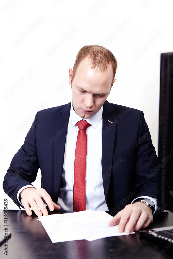Office worker signs a contract in the workplace. On the table, c Office worker signs a contract in the workplace. On the table, c