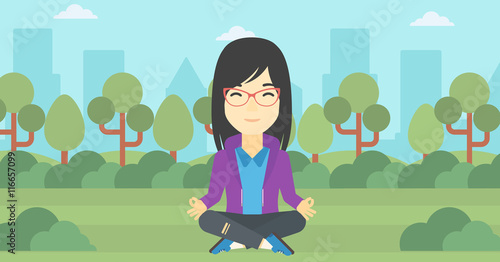Business woman meditating in lotus position.