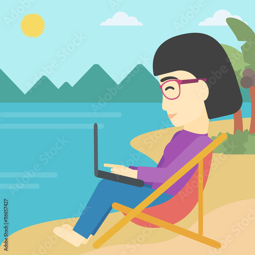Business woman working on laptop on the beach.