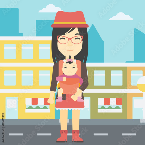 Mother carrying her daughter in sling.