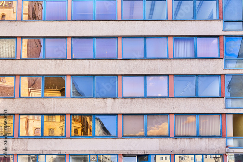 facade of an office building with orange and blue windows
