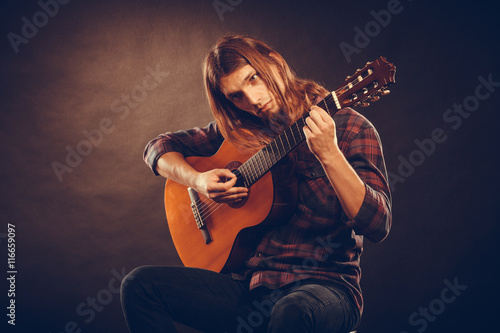 Guitarist trying out chords. photo