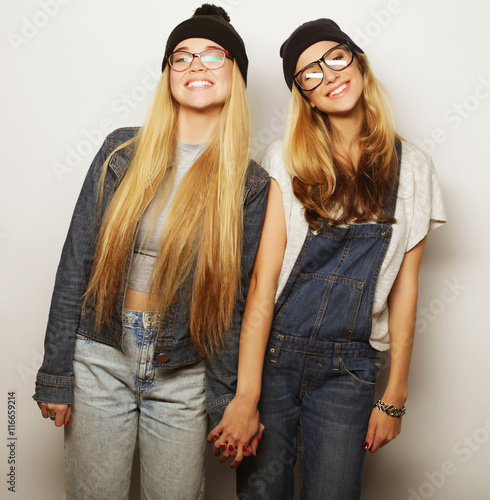  Two young girl friends standing together and having fun © Raisa Kanareva