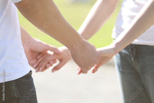Couple holding hands, close up