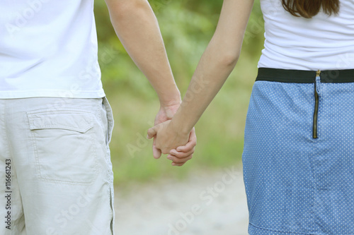 Couple holding hands, close up