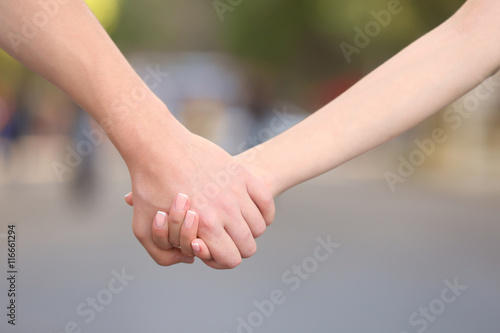 Couple holding hands, close up