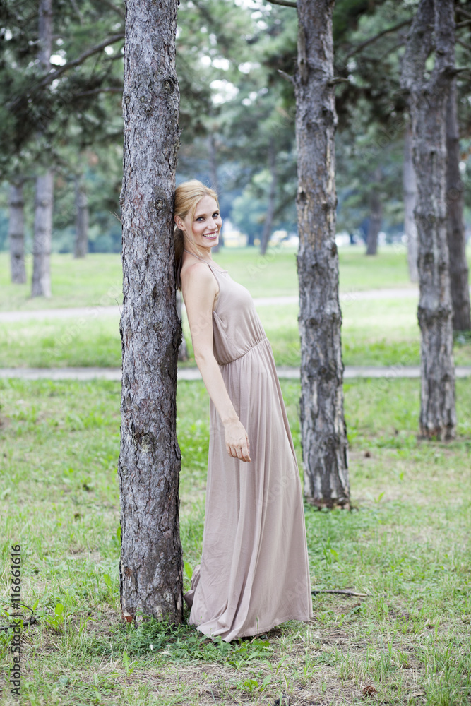 Young beautiful happy woman in park, summer outdoors