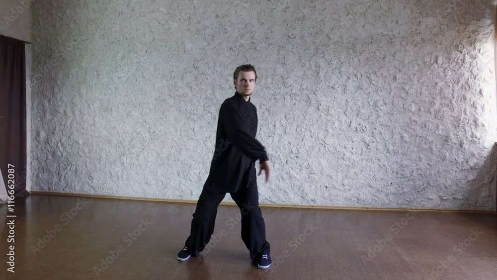 Training in the hall. Man practicing elements of tai chi. 4K Training in the hall. Man practicing elements of tai chi. 4K