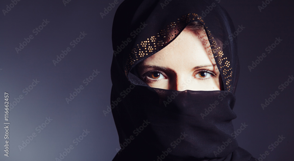 Portrait of beautiful woman with brown eyes wearing black scarf