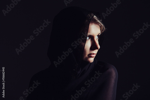 Portrait of beautiful woman with brown eyes wearing black scarf