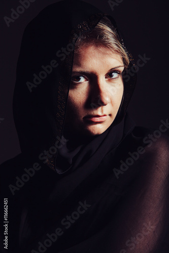 Photography Portrait of beautiful woman with brown eyes wearing black scarf