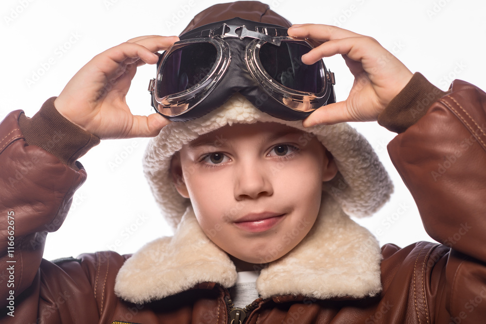 the boy is an aviator in the jacket of the pilot and in old glasses the boy is an aviator in the jacket of the pilot and in old glasses