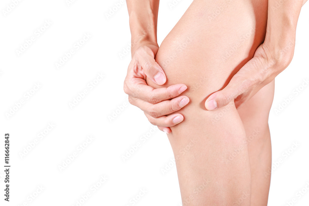 Knee pain.Female holding hand to spot of knee pain on white background.