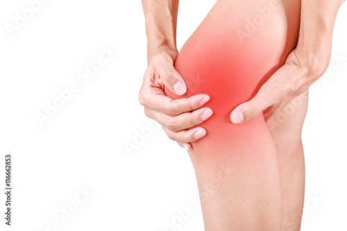 Knee pain.Female holding hand to spot of knee pain