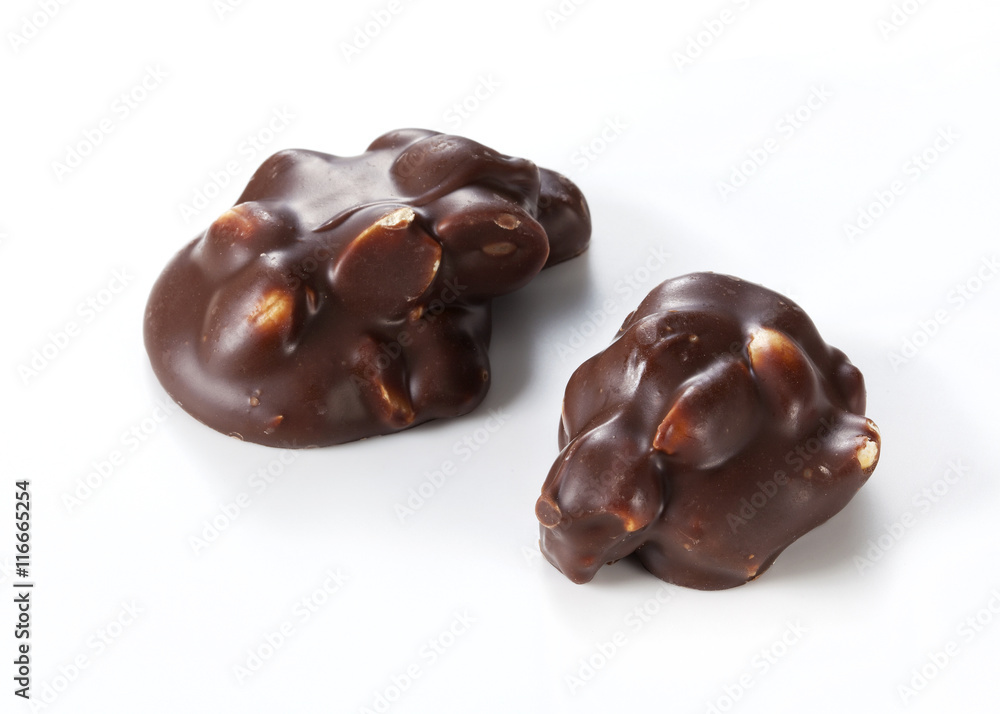 Chocolate pieces with nuts on a white background Chocolate pieces with nuts on a white background