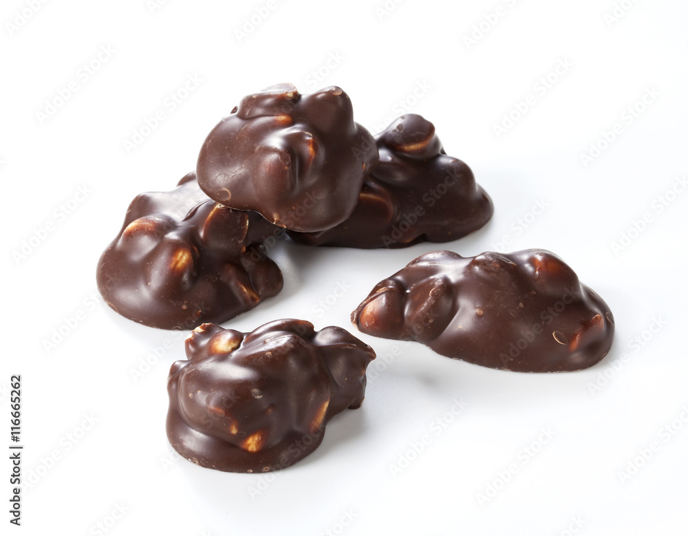 Chocolate pieces with nuts on a white background Chocolate pieces with nuts on a white background