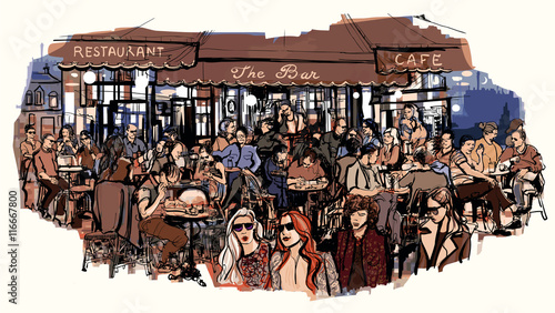 Customers at traditional outdoor Parisian cafe