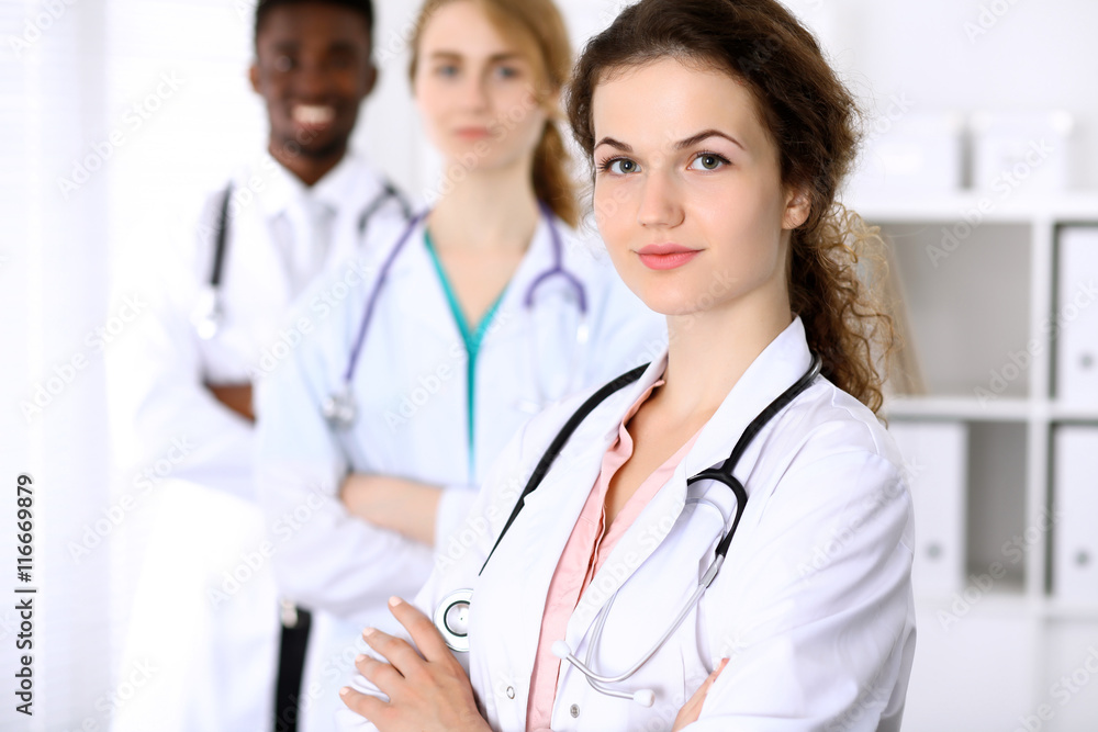 Happy doctor woman with medical staff at the hospital Happy doctor woman with medical staff at the hospital